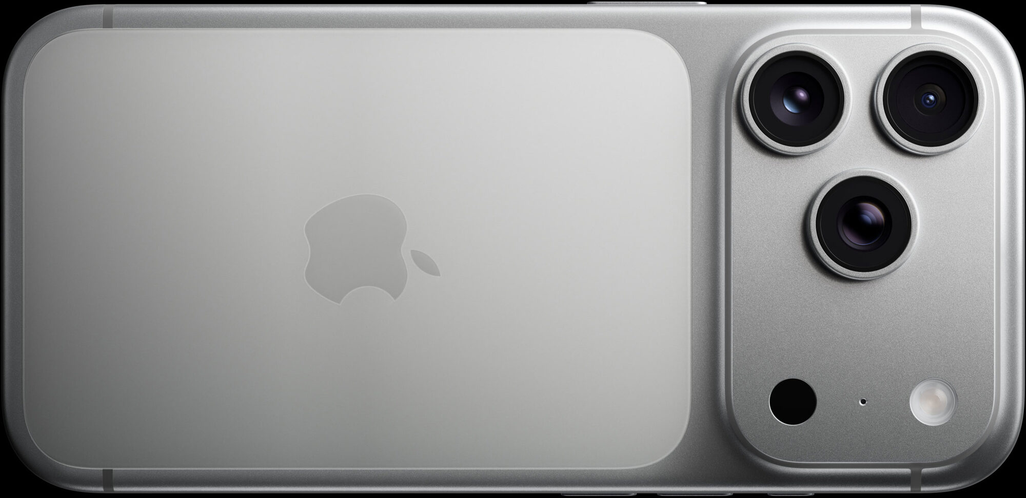 iPhone 17 Pro in silver, back glass and tri-lens camera plateau photographed against black