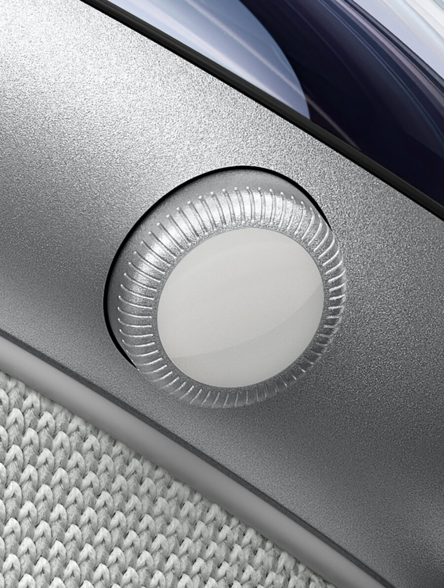 Macro study: the Digital Crown of Apple Vision Pro, knurled aluminum against woven fabric